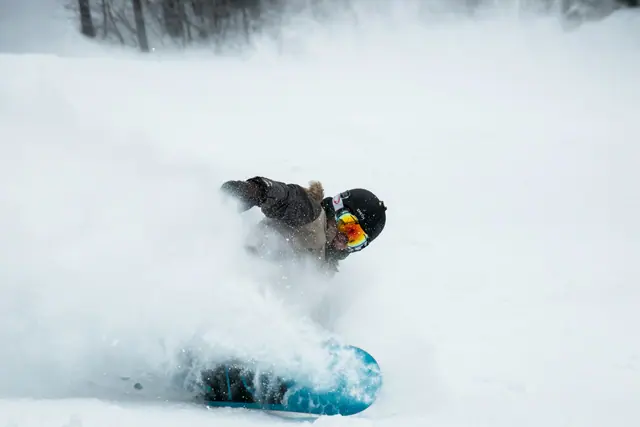 A snowboarder in fresh snow